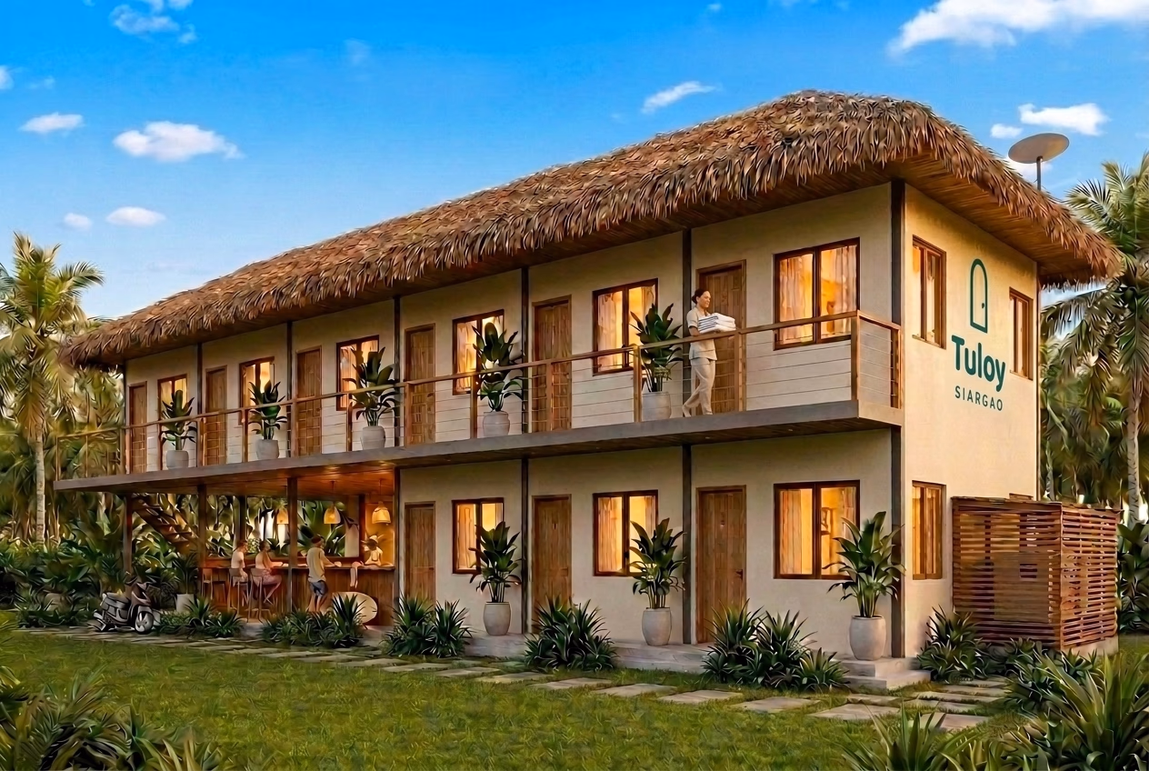 A low, palm-shaded accommodation building in General Luna, Siargao